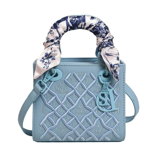 Elegant Embossed Handbag with Scarf Detail